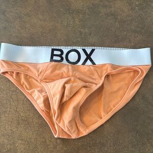 Men’s orange box, briefs, size small